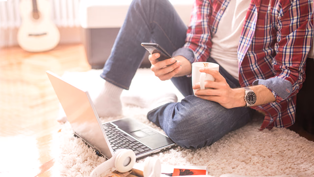 job seeker checking phone and laptop