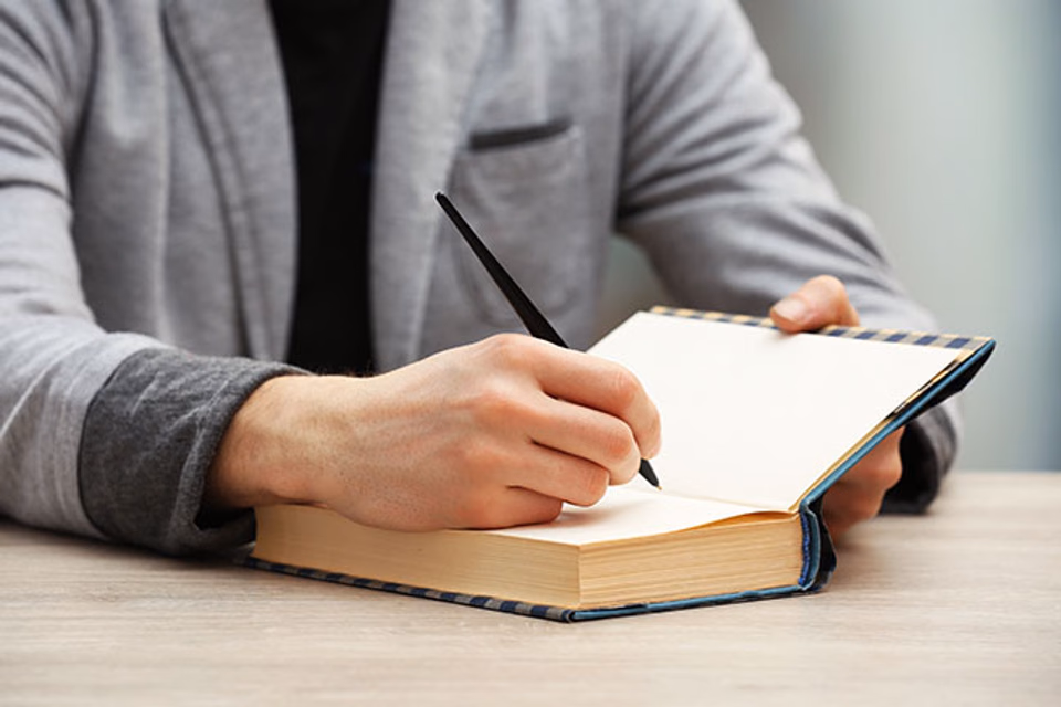 Author holding their published book