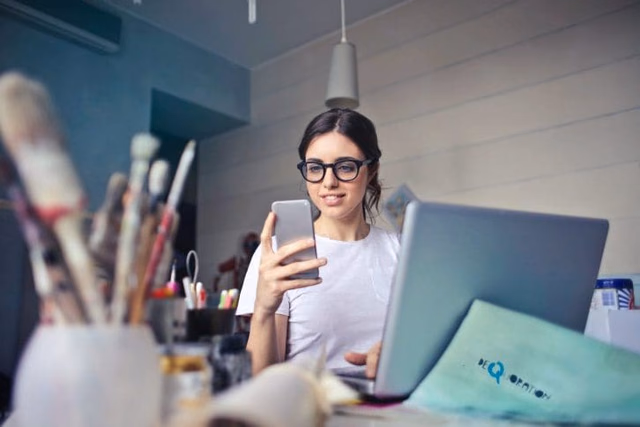 woman looks at phone