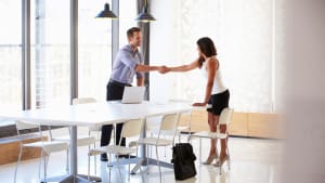 employer shaking hands with job candidate