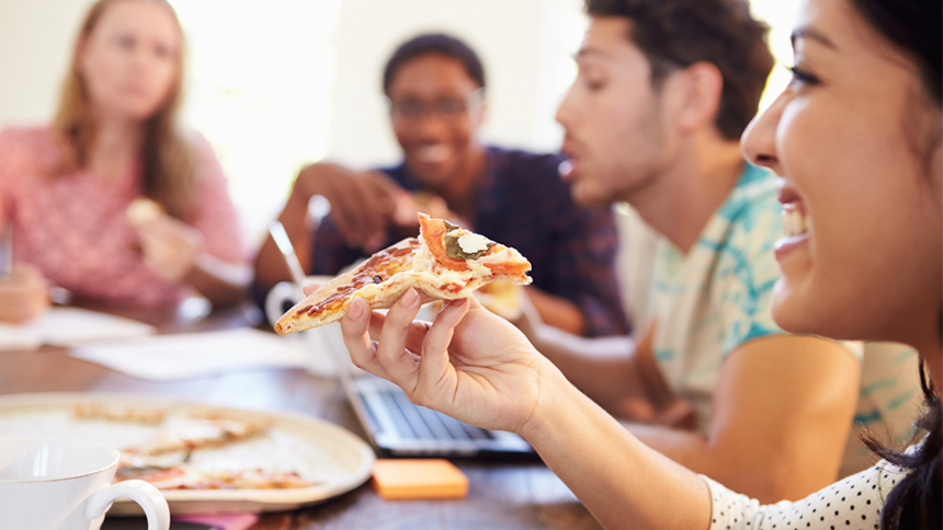 employees being rewarded eating pizza