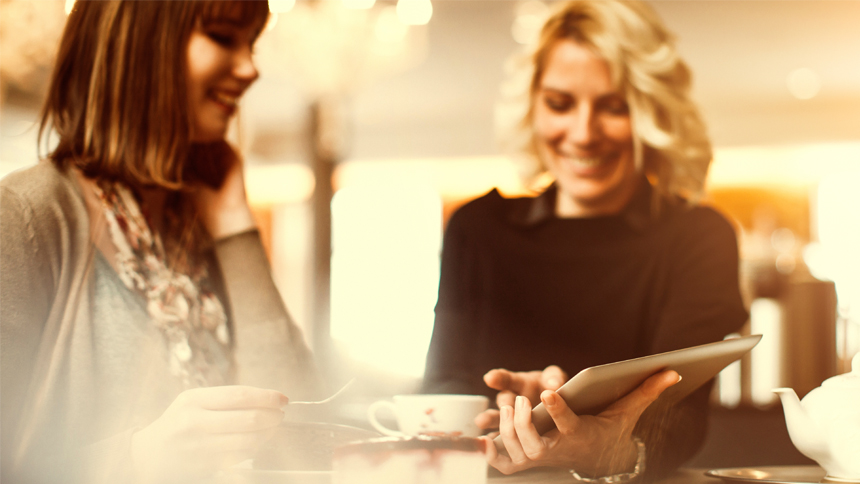 woman meeting with person at coffee shop networking