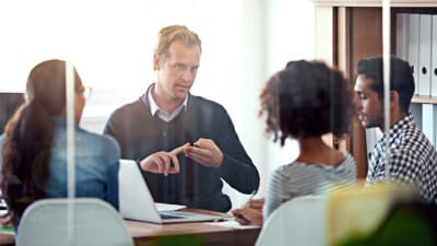 manager talking with employees in office