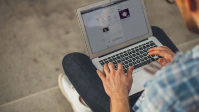 Man on laptop using LinkedIn