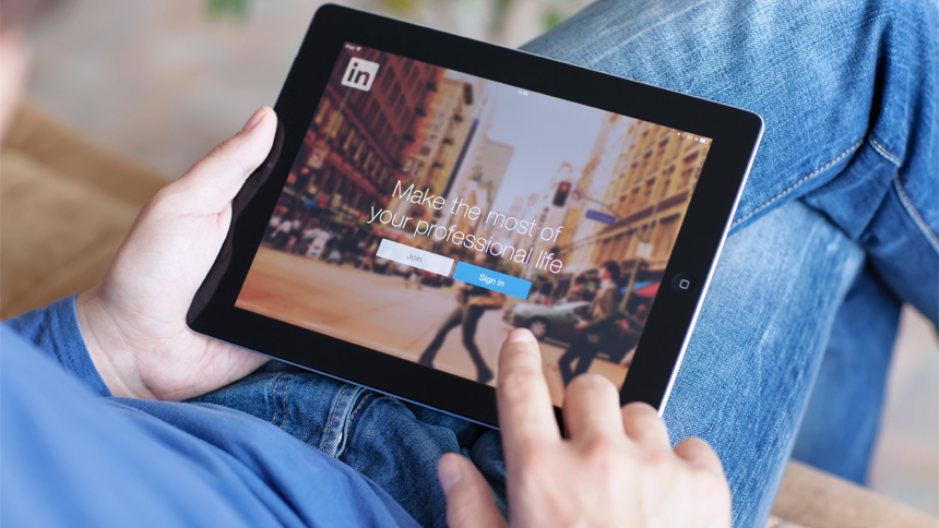 man using LinkedIn on a tablet