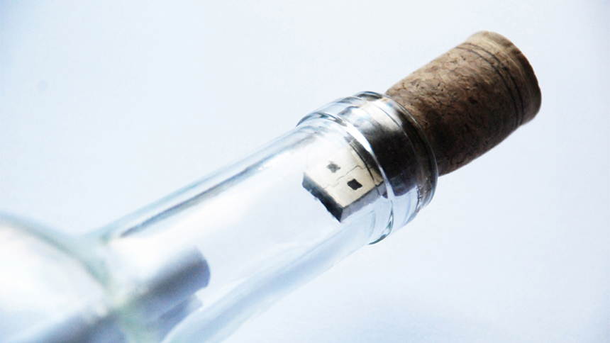 job-seeker resume in a glass bottle with thumb drive cork