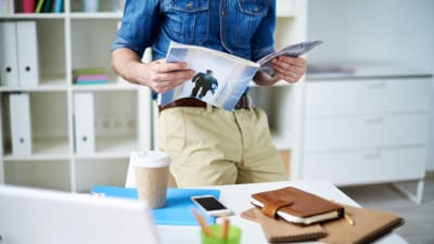 public relations professional reading a trade magazine