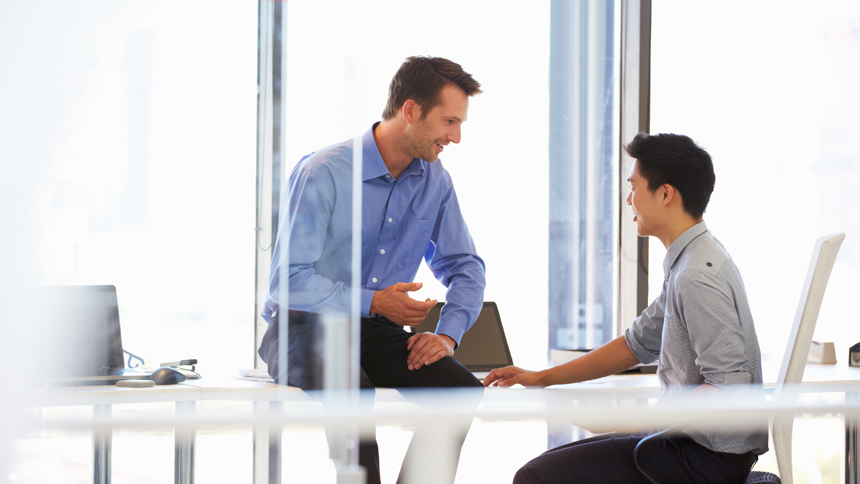 young employee meeting with his mentor in office