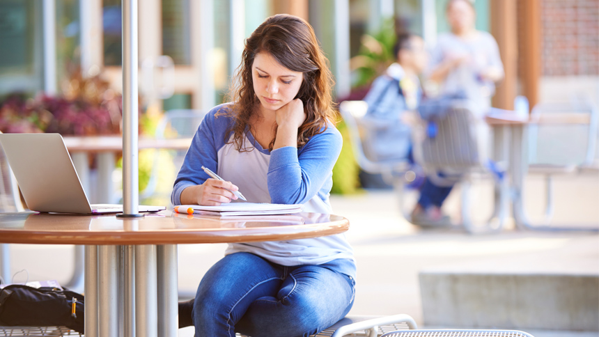 job candidate researching an ad agency at a coffee shop