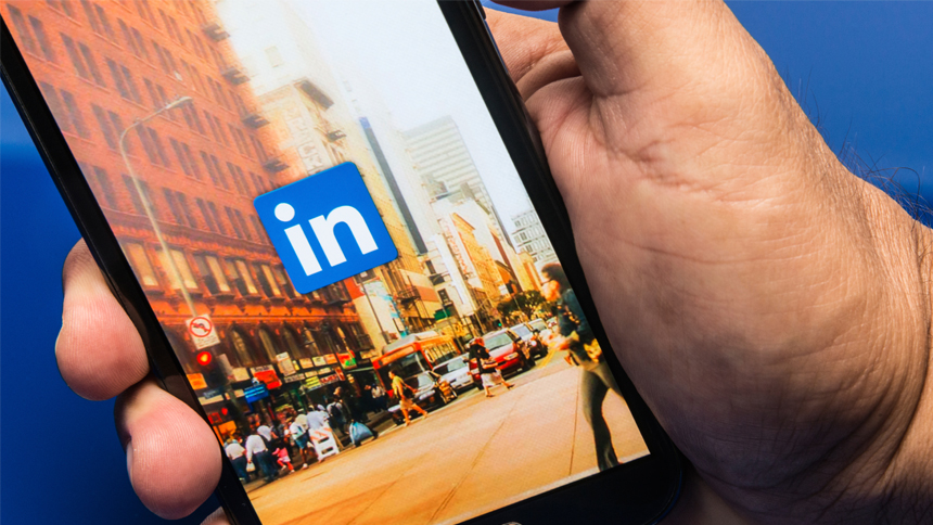 hand holding phone with Linkedin app opened