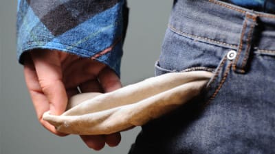 man holding open empty pocket, working for free