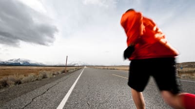 Man running a marathon on the open road