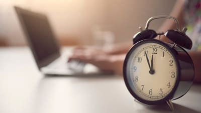 Woman writing under the clock