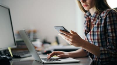 Woman at desk distracted while working