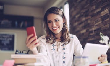 woman cell phone laptop