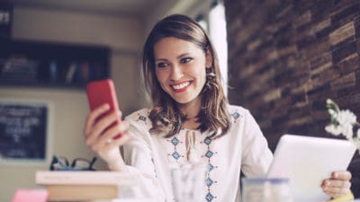 woman cell phone laptop