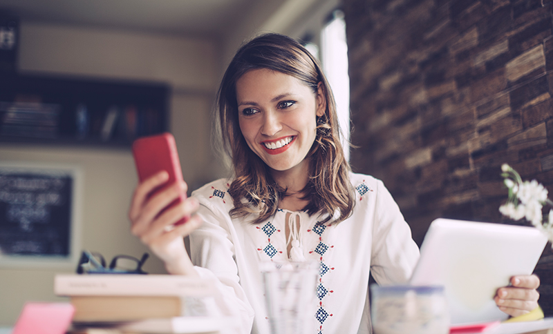 woman cell phone laptop