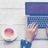 woman typing laptop tea flowers