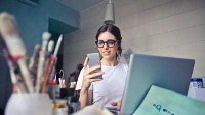 woman looks at phone