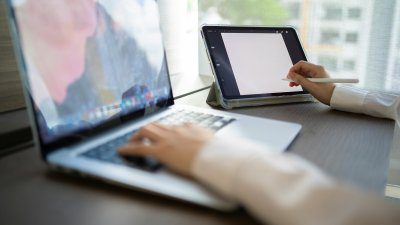 creative professional working on a computer with a stylist